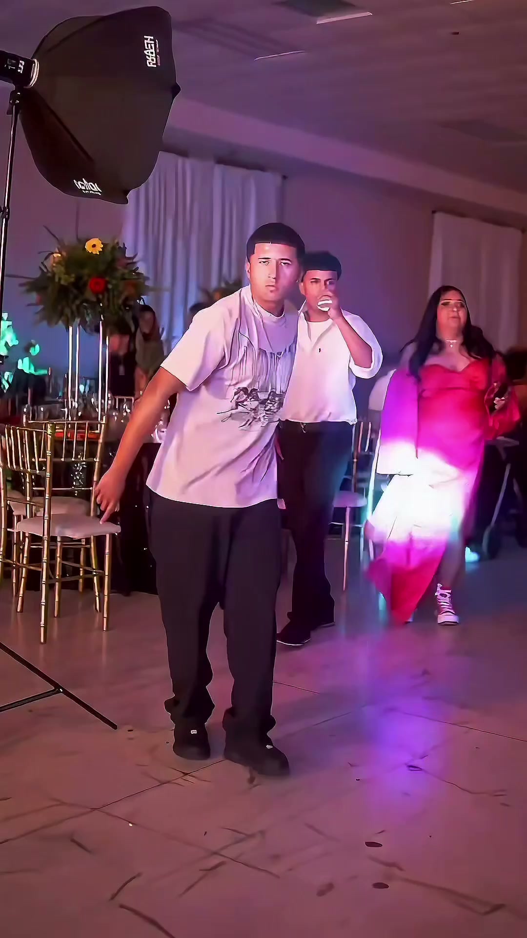 Reference frame of a lead performer walking through a colored party hall